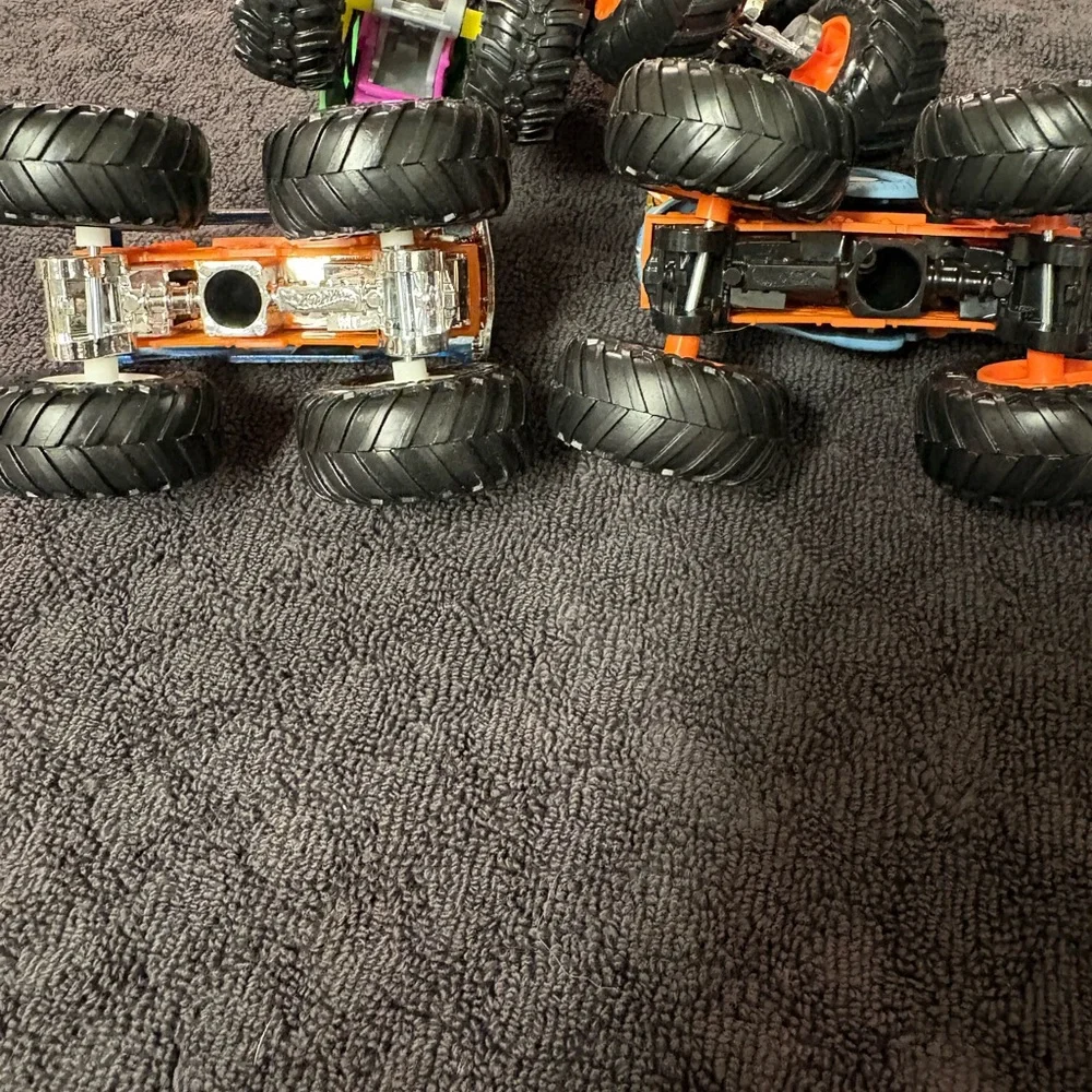 Hot Wheels 4 lot of Monster Truck Toys. Assorted Colors (Green, Orange, Blue)